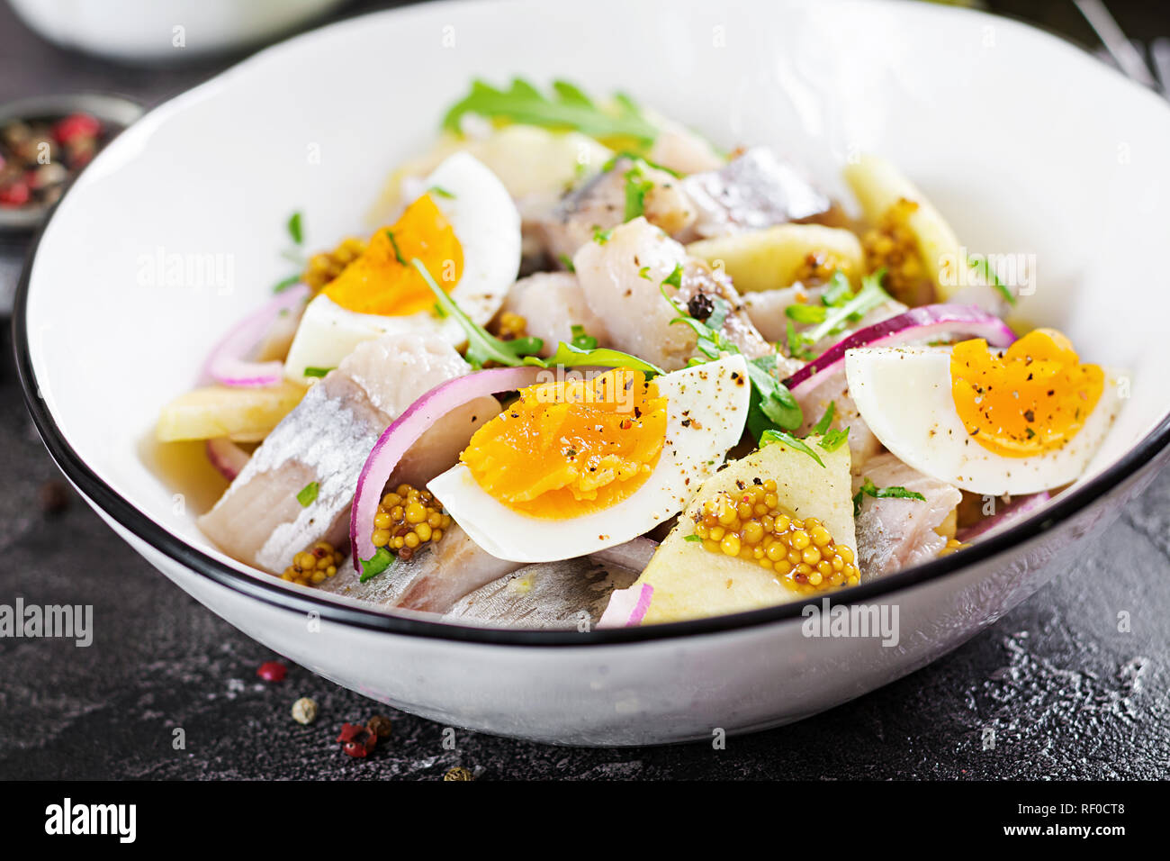 Traditional salad of salted herring fillet, fresh apples, red onion and