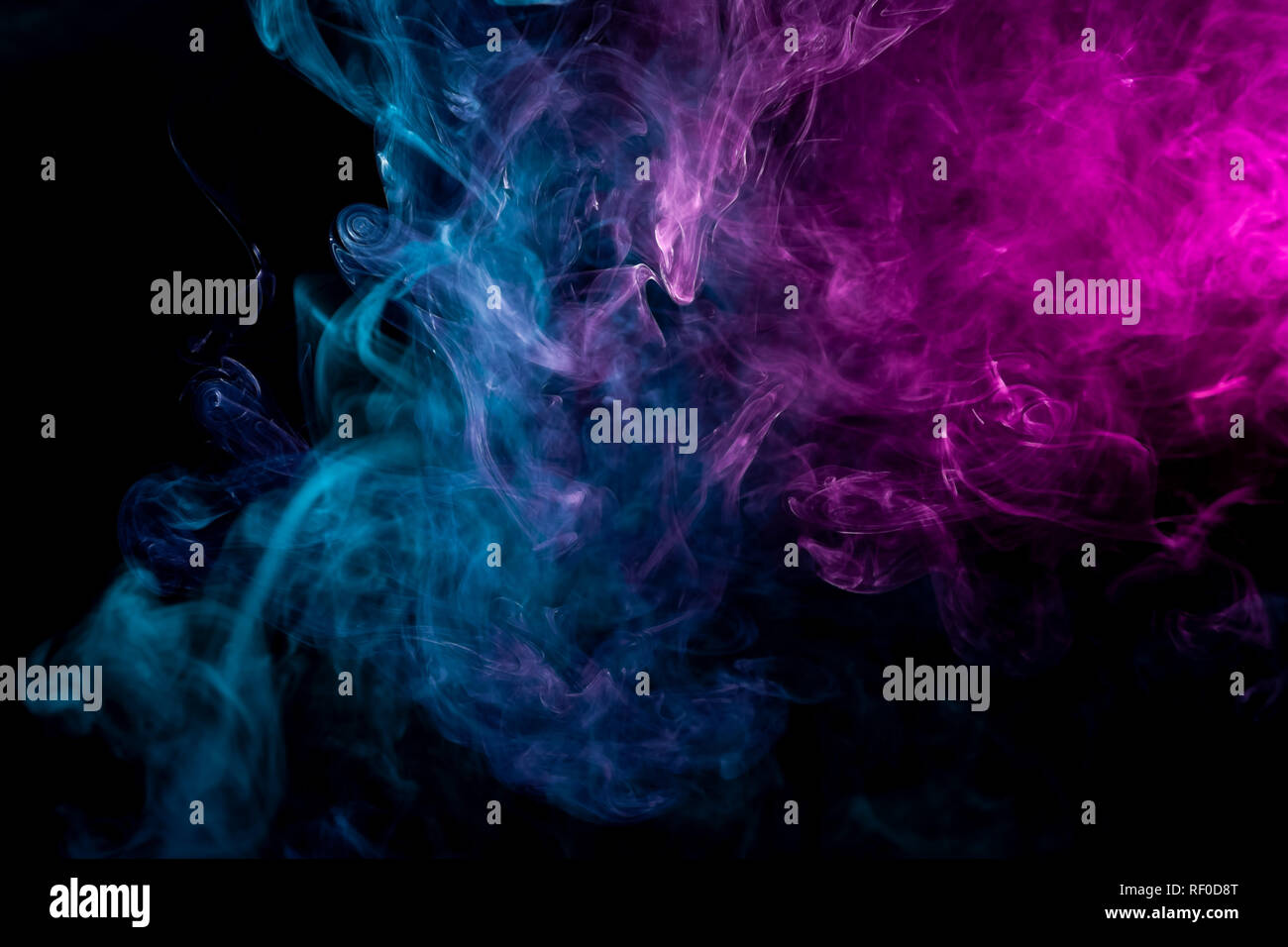 Pink and blue smoke on black background Stock Photo - Alamy