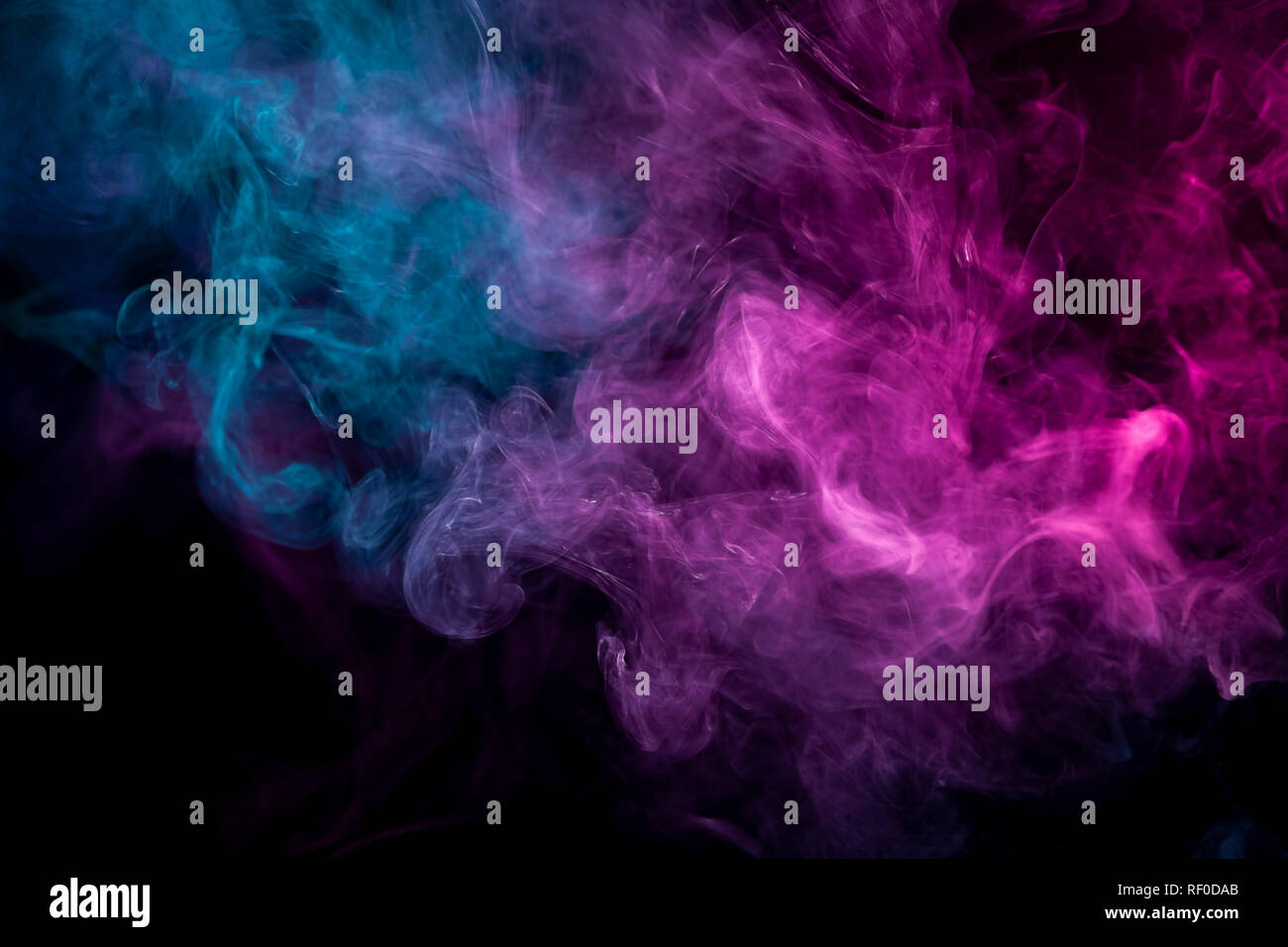 Close up swirling pink and blue smoke on black background Stock Photo ...