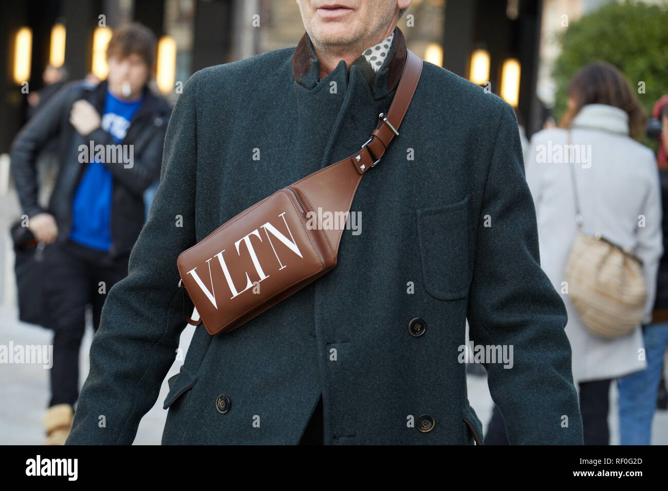 MILAN, ITALY - JANUARY 12, 2019: Man with brown leather Valentino pouch  before Neil Barrett fashion show, Milan Fashion Week street style Stock  Photo - Alamy