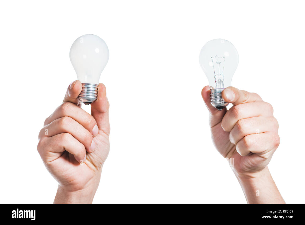cropped view of male hands holding led lamps in hands isolated on white, energy efficiency concept Stock Photo