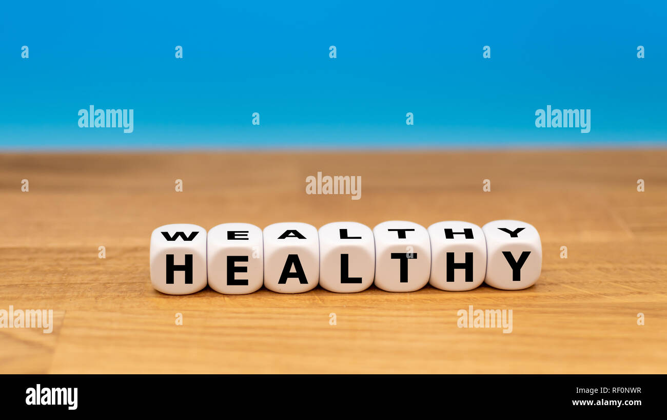 Dice form the words 'wealthy' and 'healthy' Stock Photo