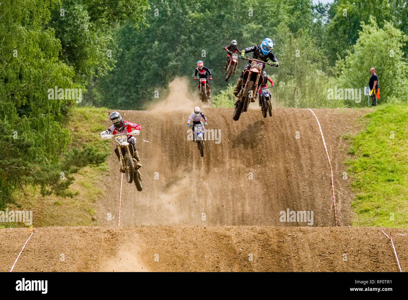 Riders on 250 cc motocross bikes jumping at Deutsche Meisterschaft at