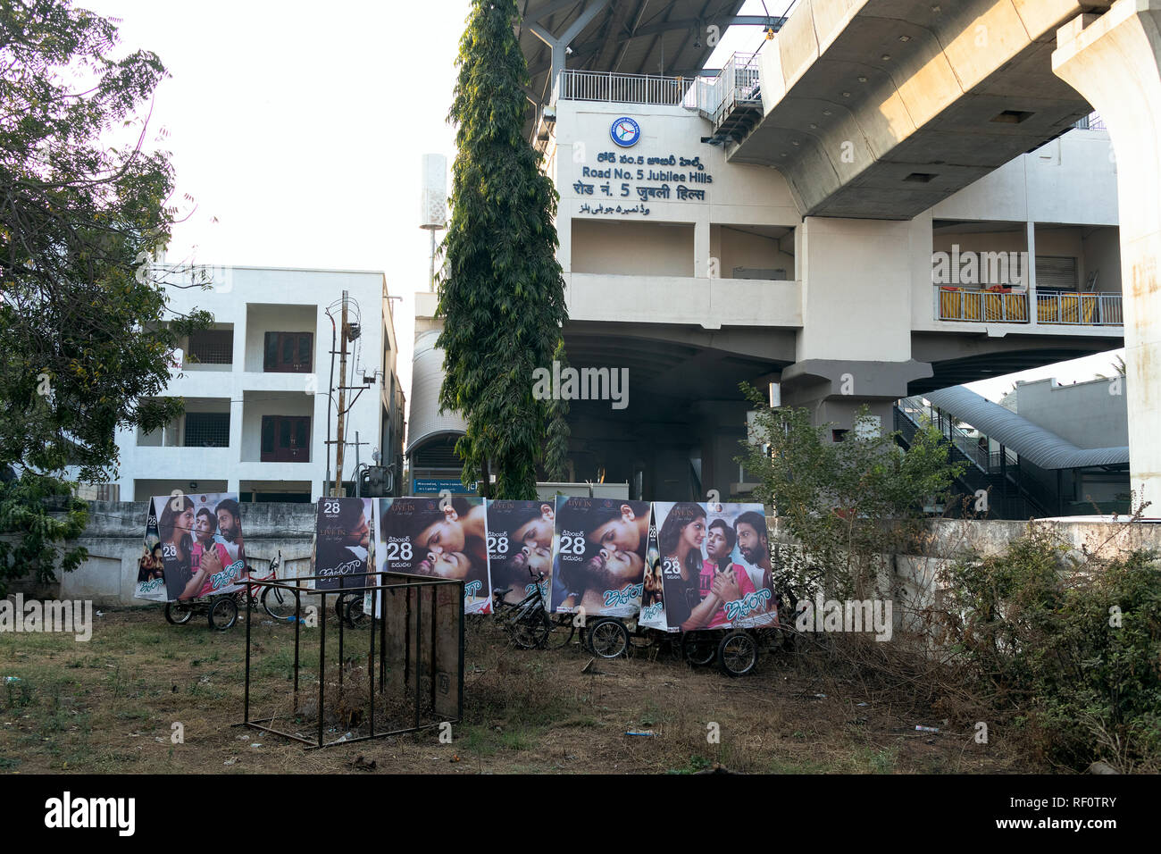 23 January 2019,Hyderabad,India.Tollywood cinema posters on a rickshaw in the foreground at Rd No 5 Jubilee Hills Metro Station in Hyderabad,India Stock Photo
