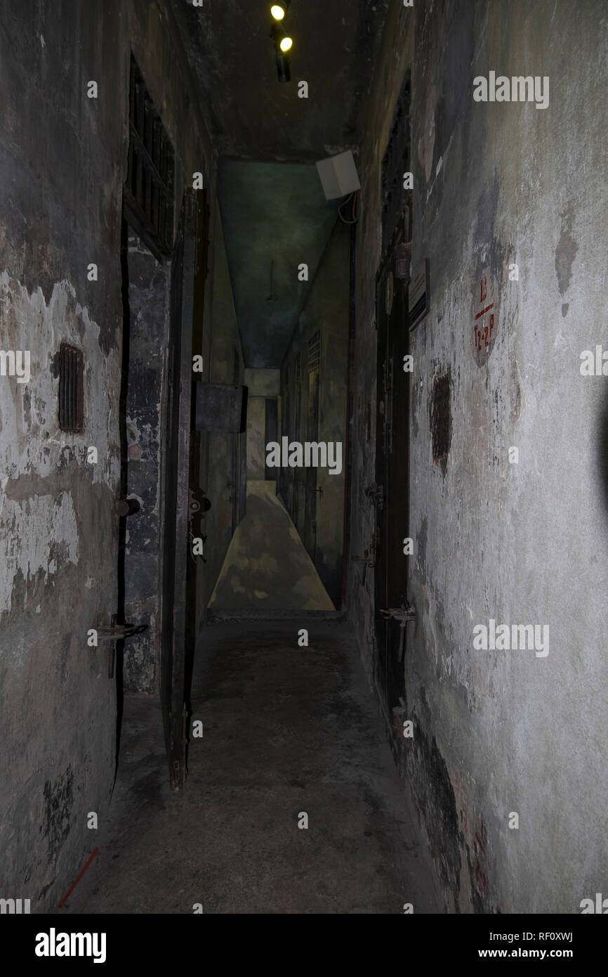 Looking down a hallway of cells at the Hanoi Hilton prison museum in Hanoi, Vietnam. Stock Photo