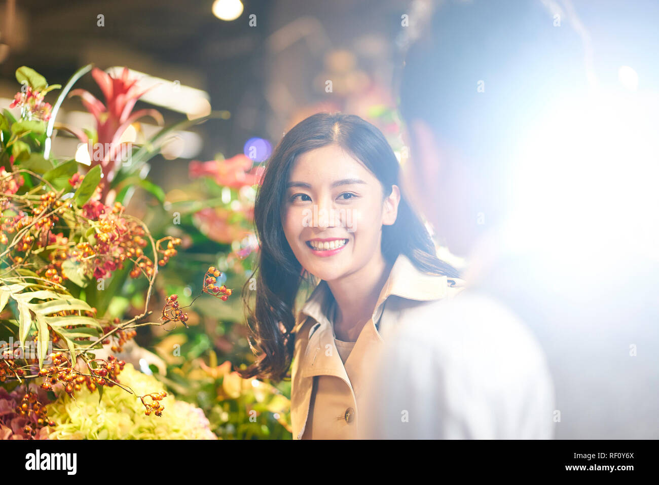 happy young asian couple choosing and buying flowers Stock Photo