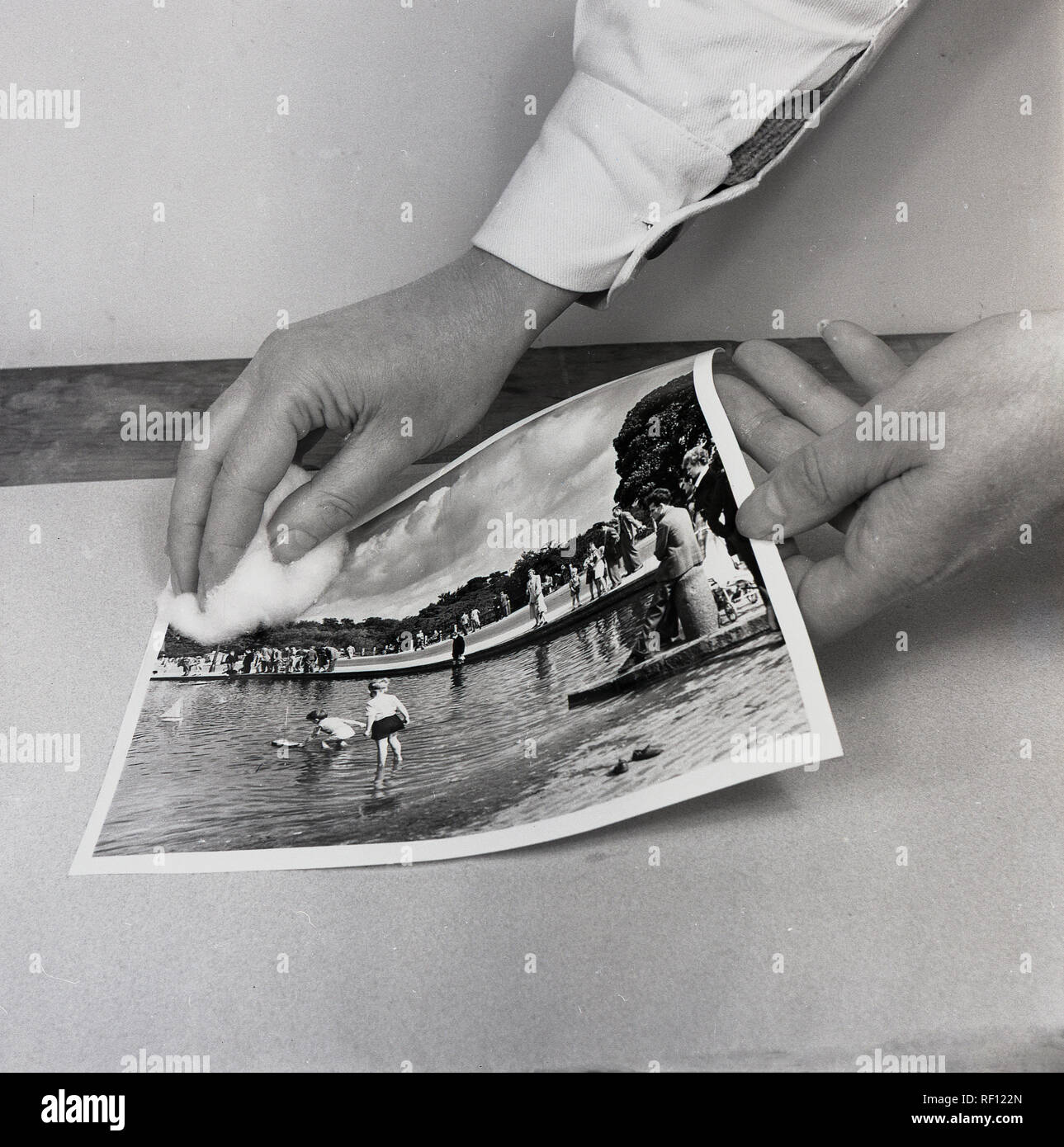 1950s, historical, photography, wiping a new print produced from the photographic film negative