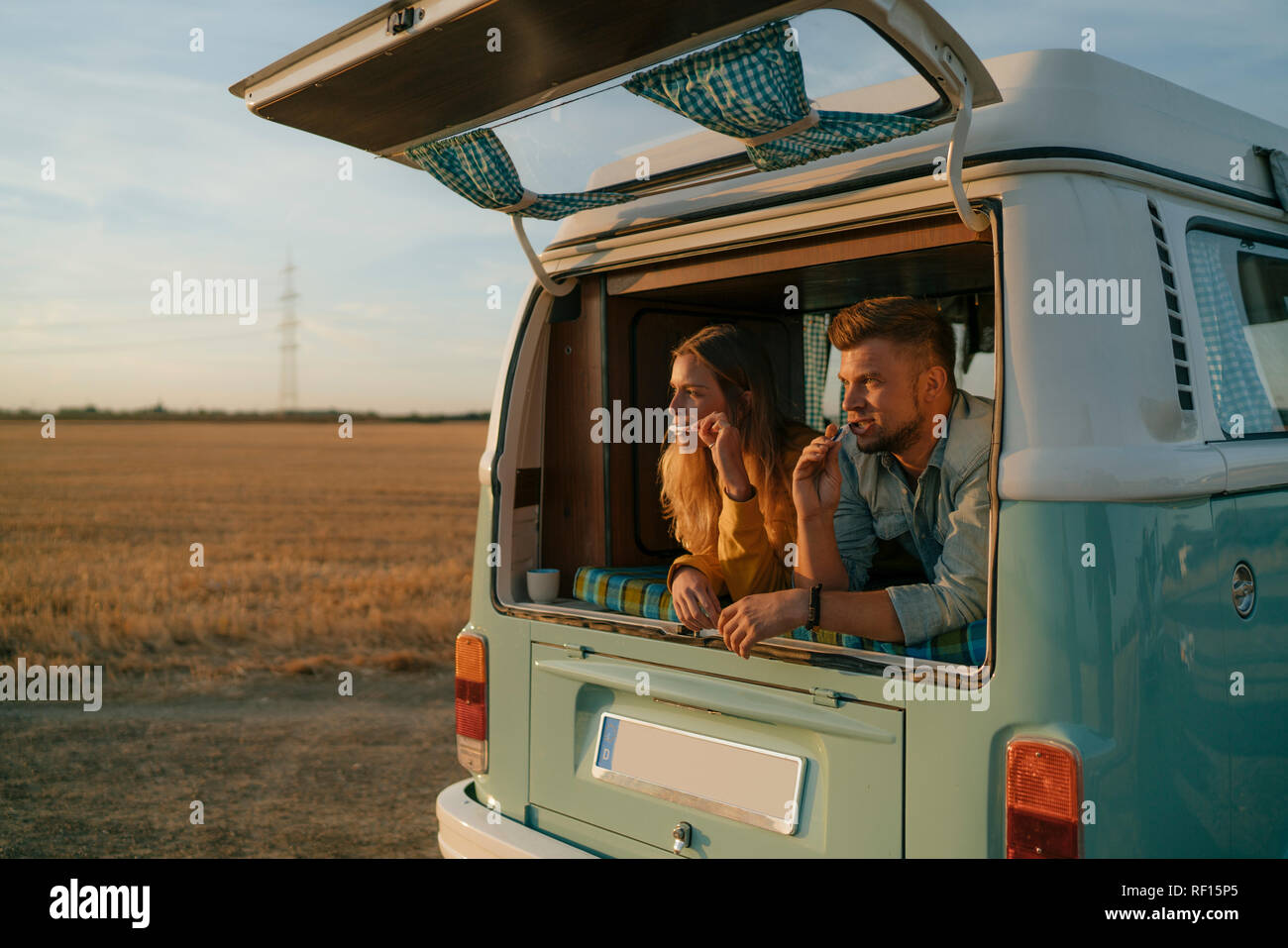 Couple brushing teeth in camper van in rural landscape Stock Photo - Alamy