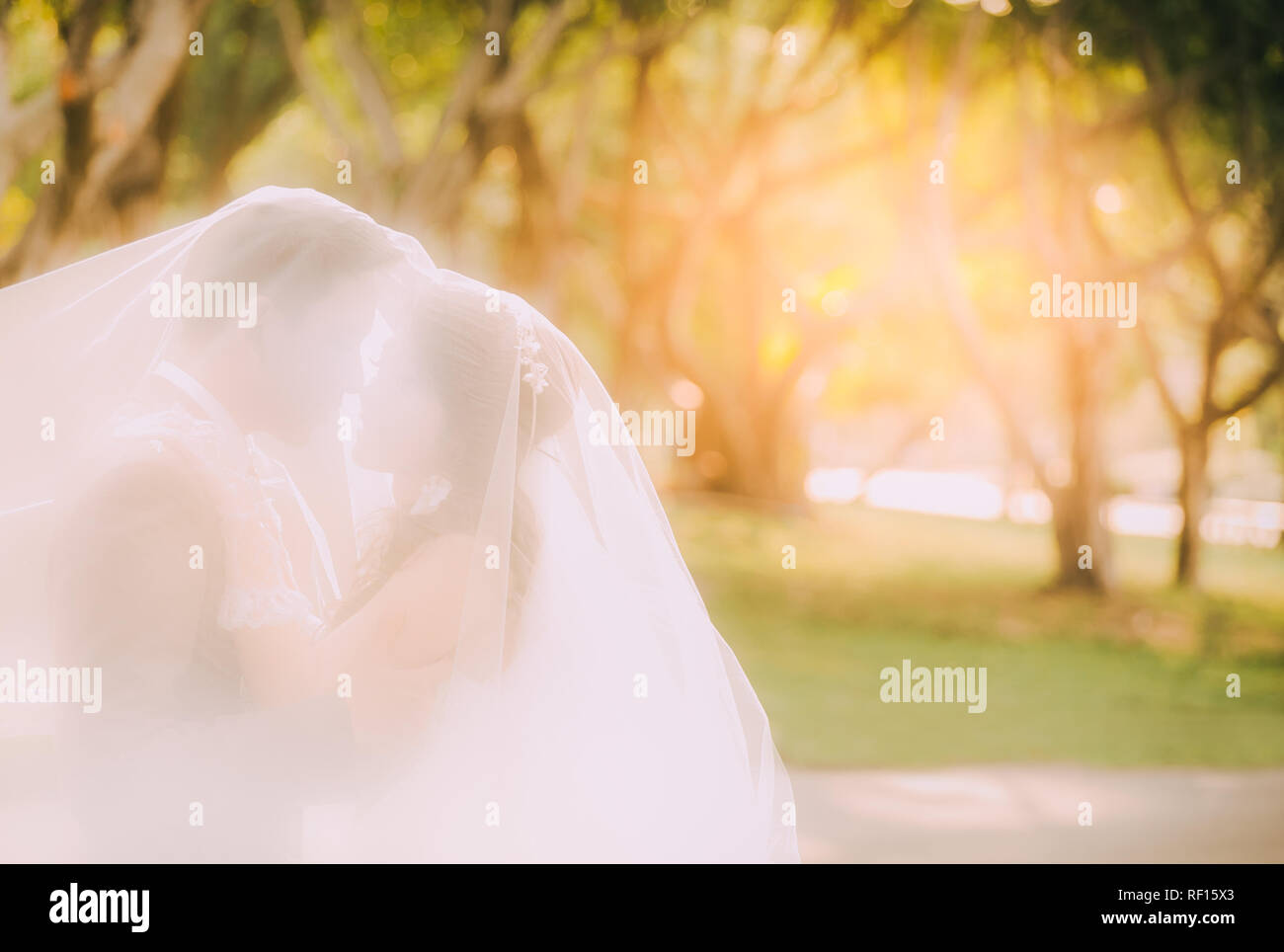 Smooth blur of bride and groom at sunset in wedding ceremony Stock