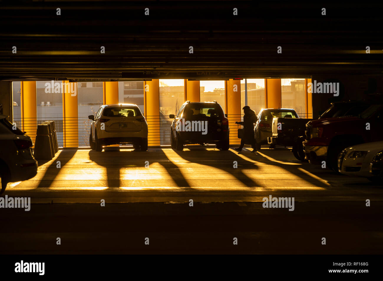 Woman With Early Morning Light Streaming Into Parking Garage, Boston, USA Stock Photo