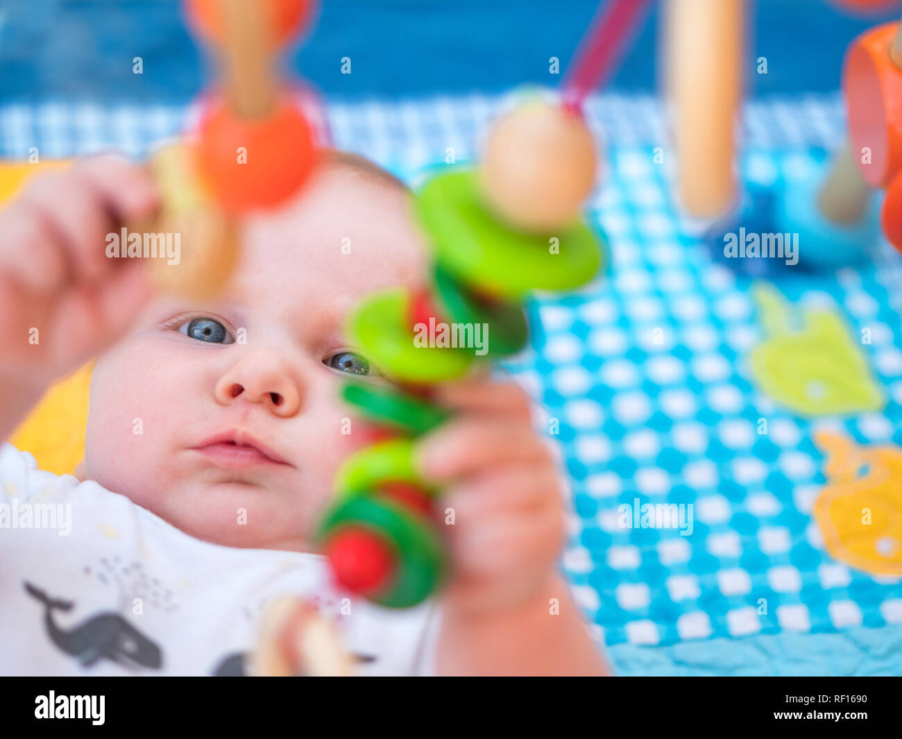 Portrait of baby girl playing with wooden toys Stock Photo
