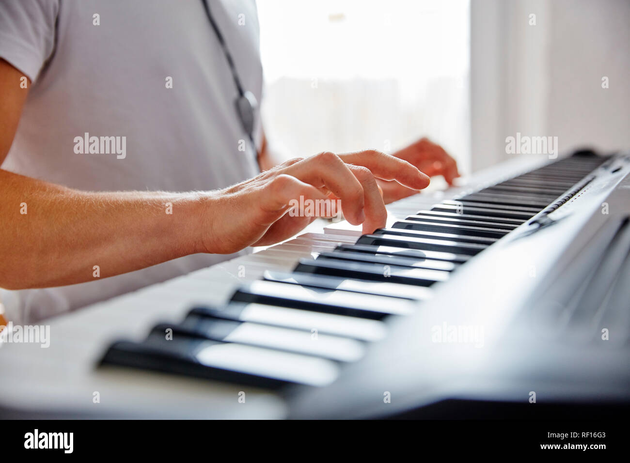 Hands of man playing digital piano Stock Photo
