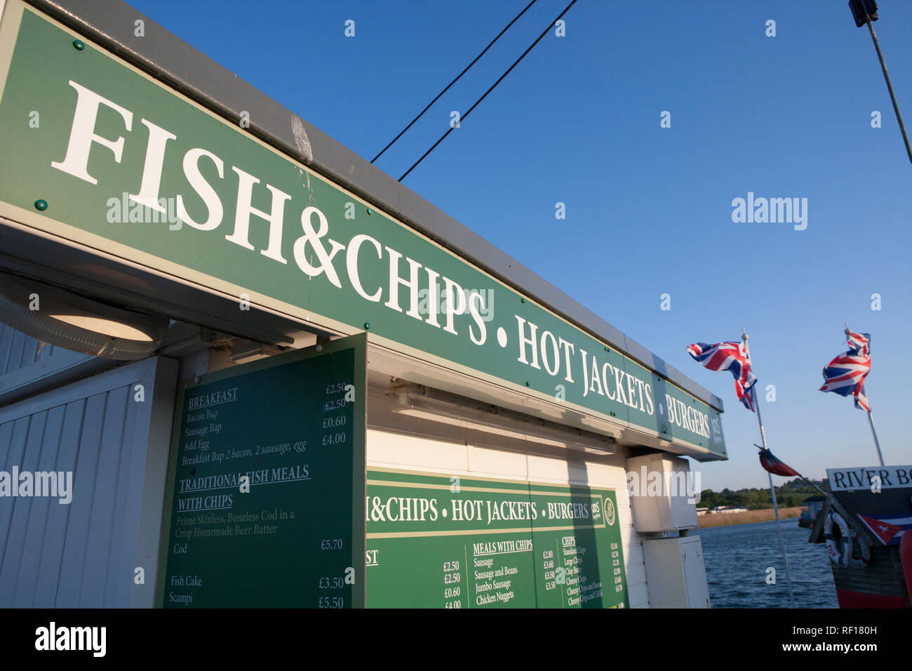 Union Jacks, or Union Flags, flying next to a fish and chip shop on