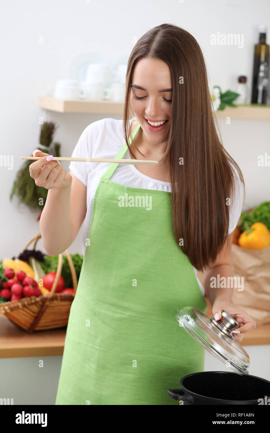 Young woman cooking with pan in kitchen, hands closeup. Householding, tasty food concepts Stock
