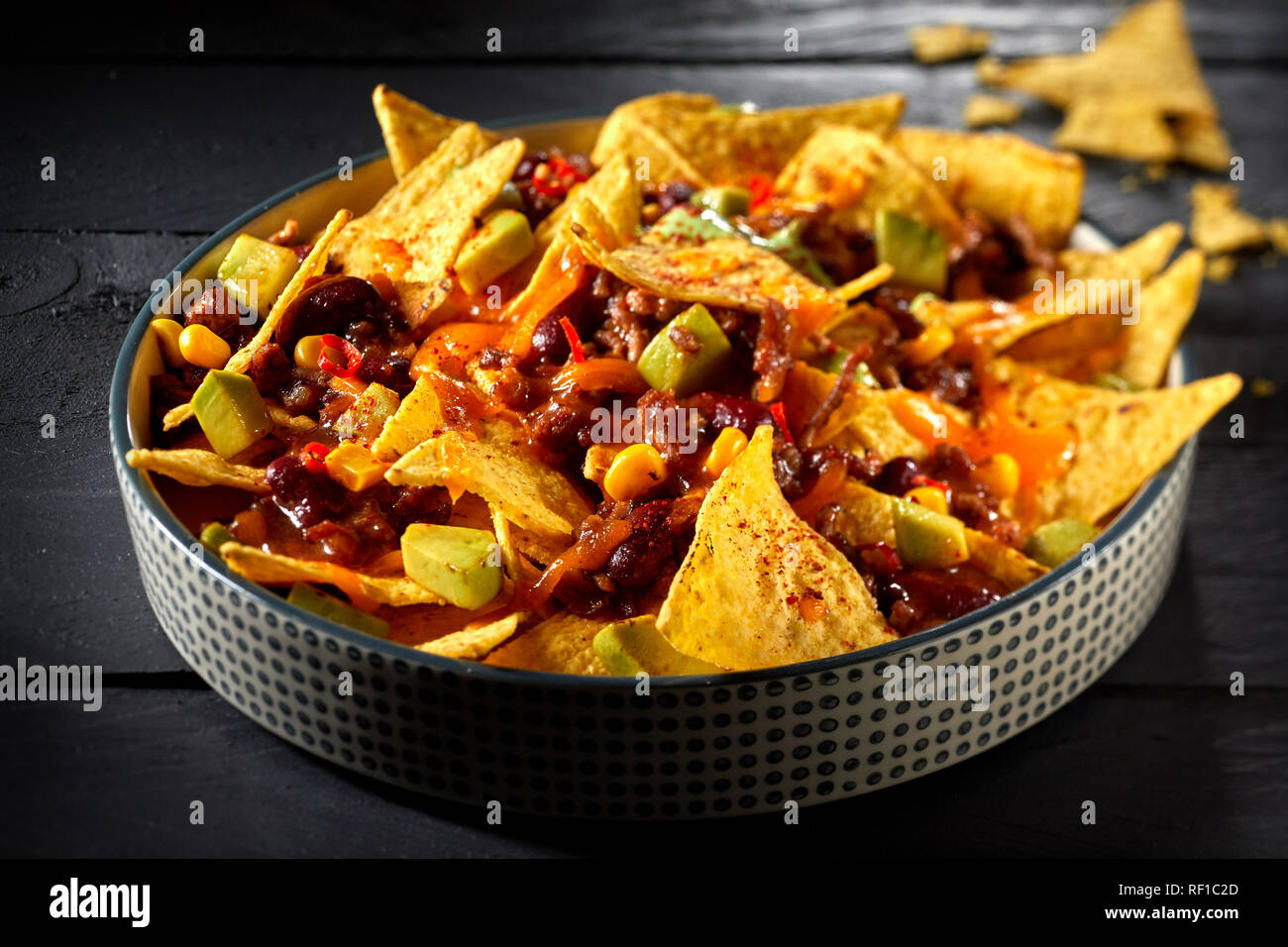 Delicious speciality chili con carne with nachos and melted cheese