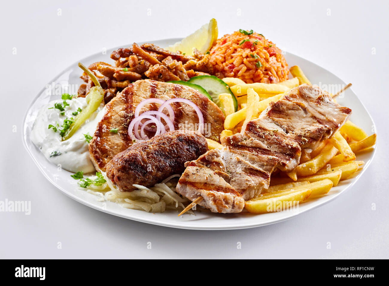 Mixed grill Greek platter with souvlaki, souzuki steak and spicy pork
