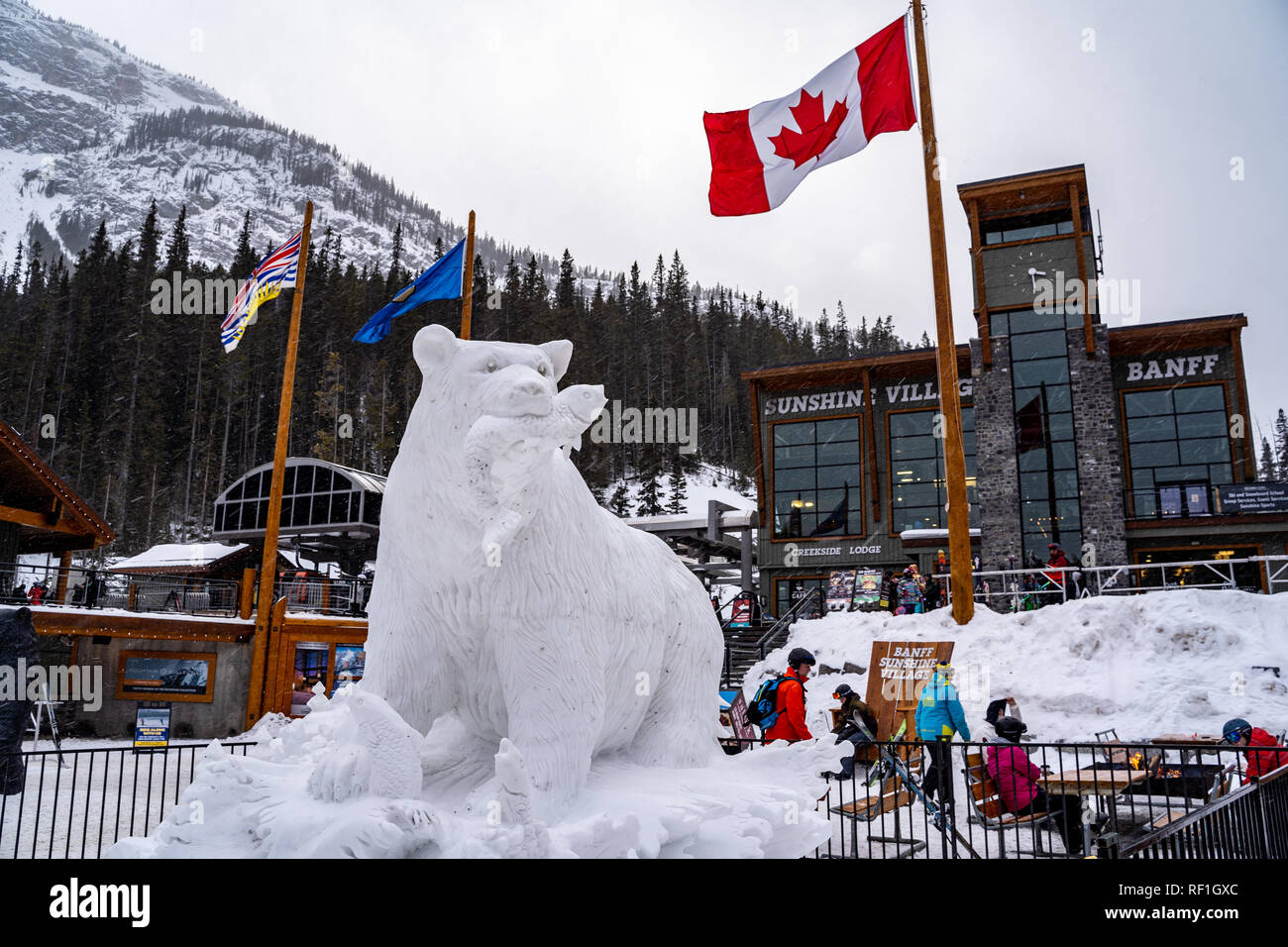 Banff, Alberta Canada - Janurary 19, 2019: Sunshine Village ski area during Banff Snow Days, with snow carving sculpture of a bear in front of the lod Stock Photo