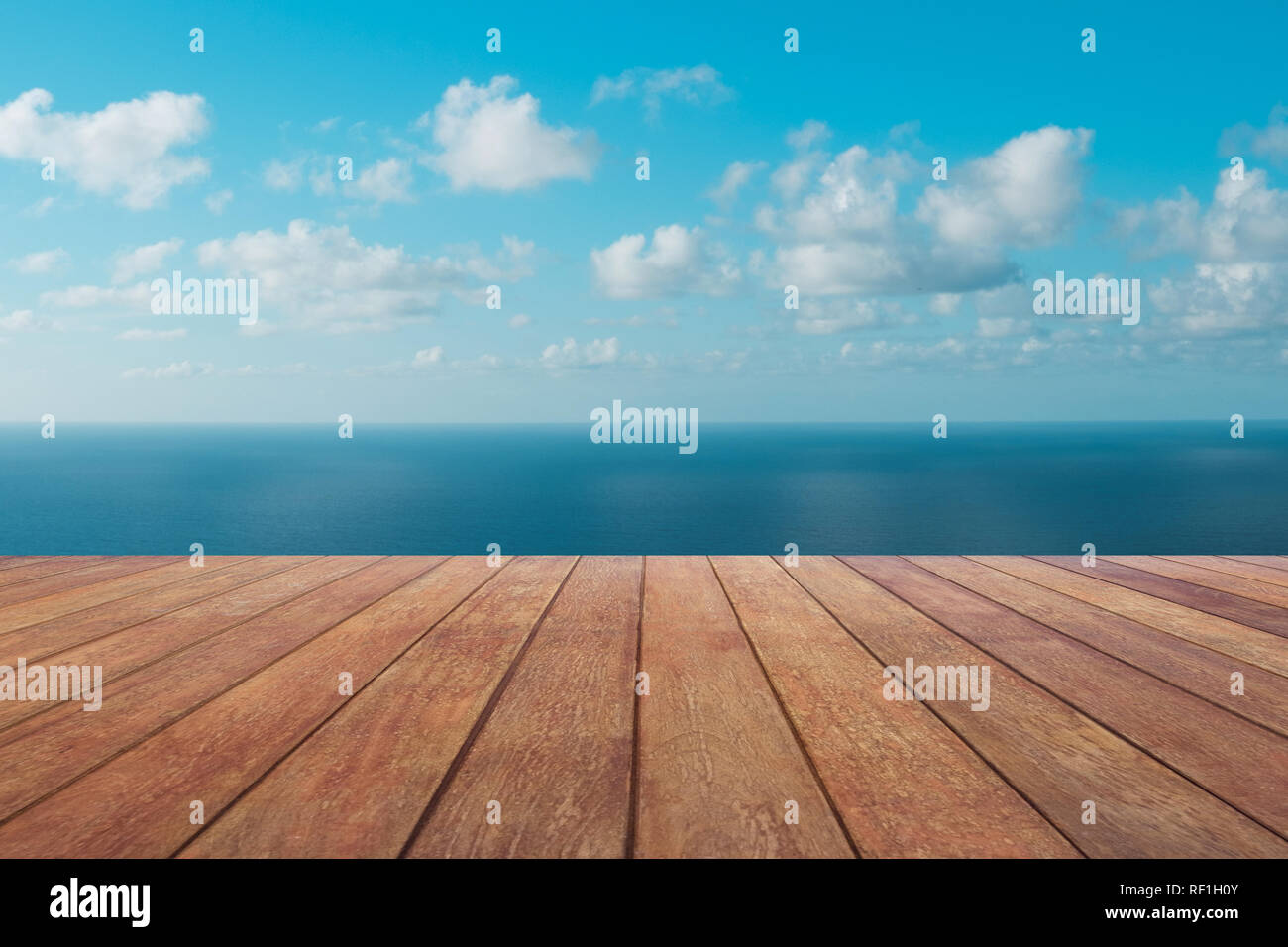 wooden board floor with ocean  and blue sky background Stock Photo