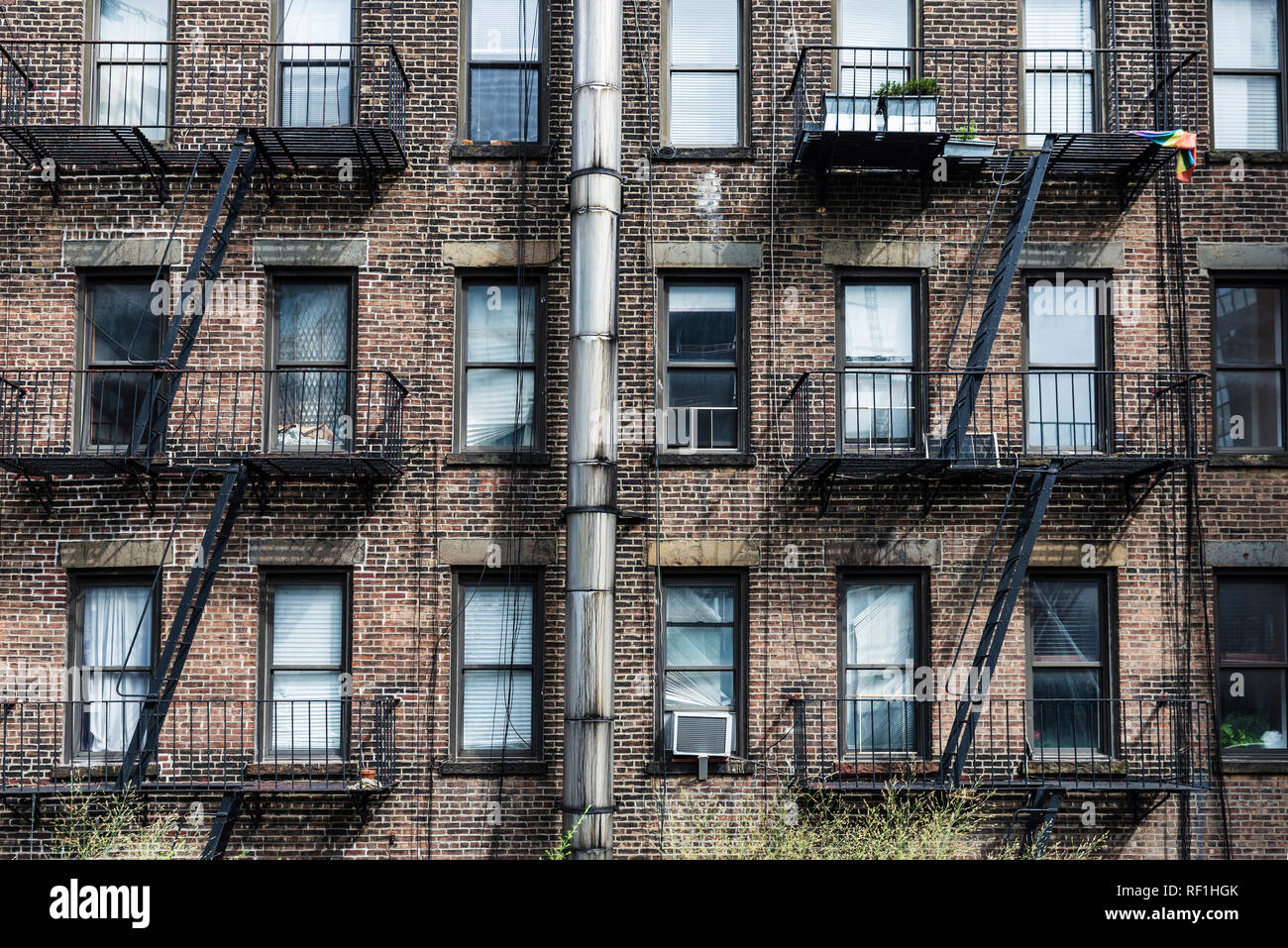 Facade of an old typical brick house with its emergency stairs in Manhattan, New York City, USA Stock Photo