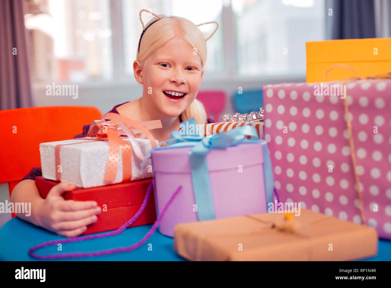 Cute teenager embracing her gift boxes at home Stock Photo Alamy