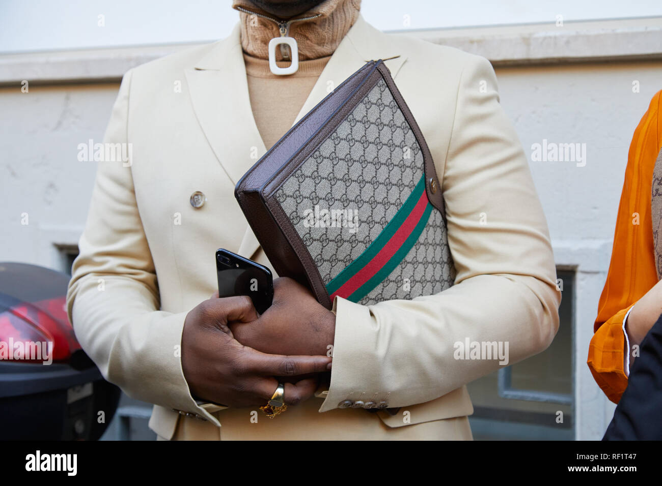 MILAN, ITALY - JANUARY 13, 2019: Man with Gucci leather bag and beige  jacket before John Richmond fashion show, Milan Fashion Week street style  Stock Photo - Alamy