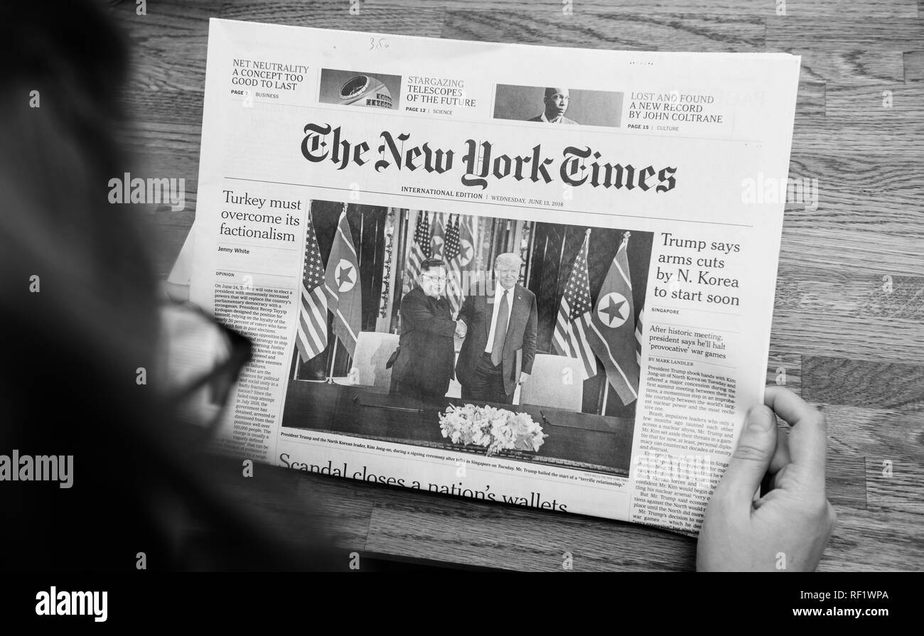 PARIS, FRANCE JUNE 13, 2018 Woman reading The New York Times