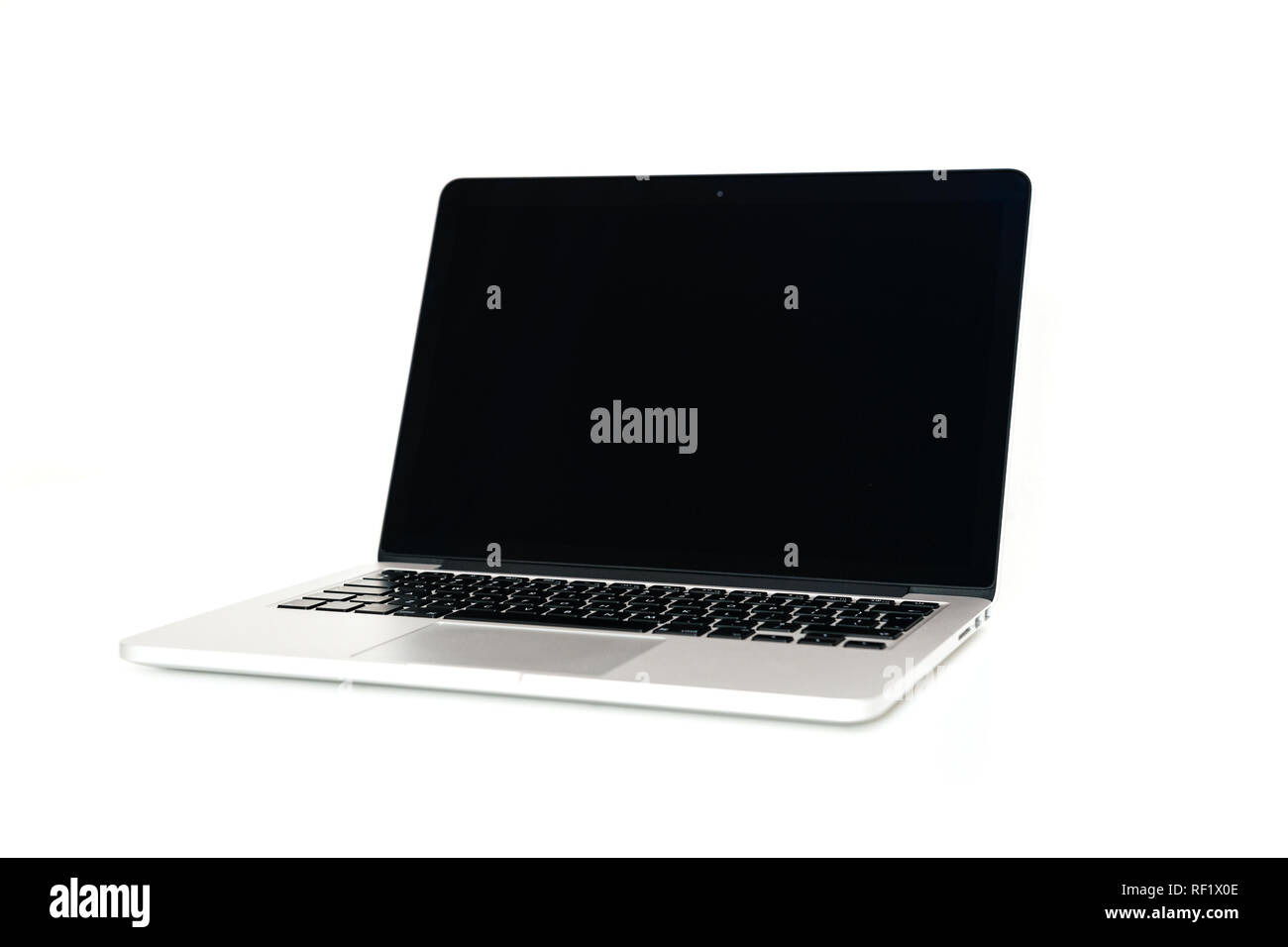 Silver computer on white table in white background studio Stock Photo