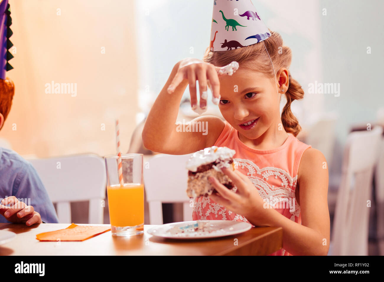 Positive delighted blonde girl looking at her hand Stock Photo