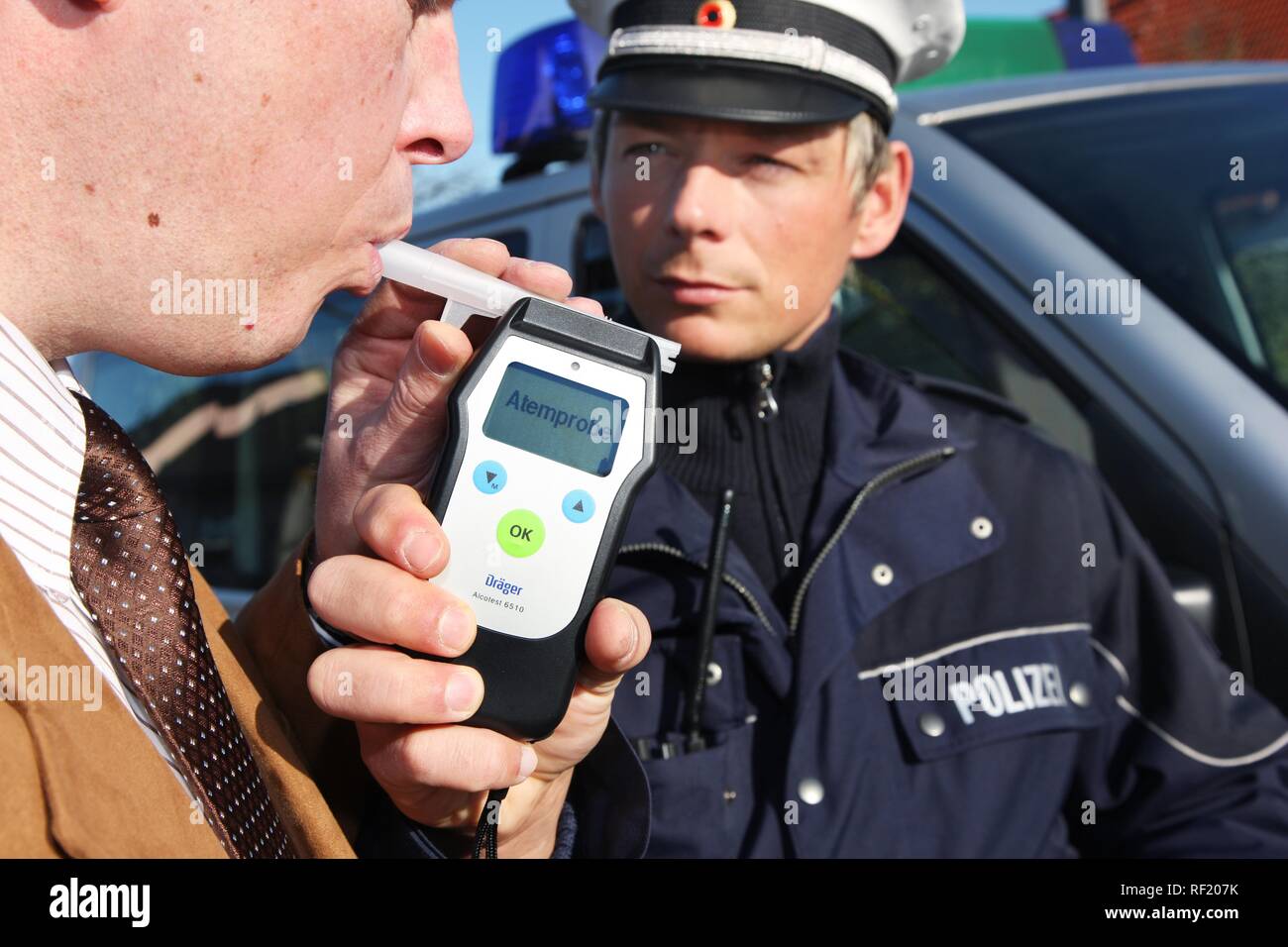 Alcohol breath test, driver being tested with a breathalyzer, breathalyser, Mettmann, North Rhine-Westphalia Stock Photo