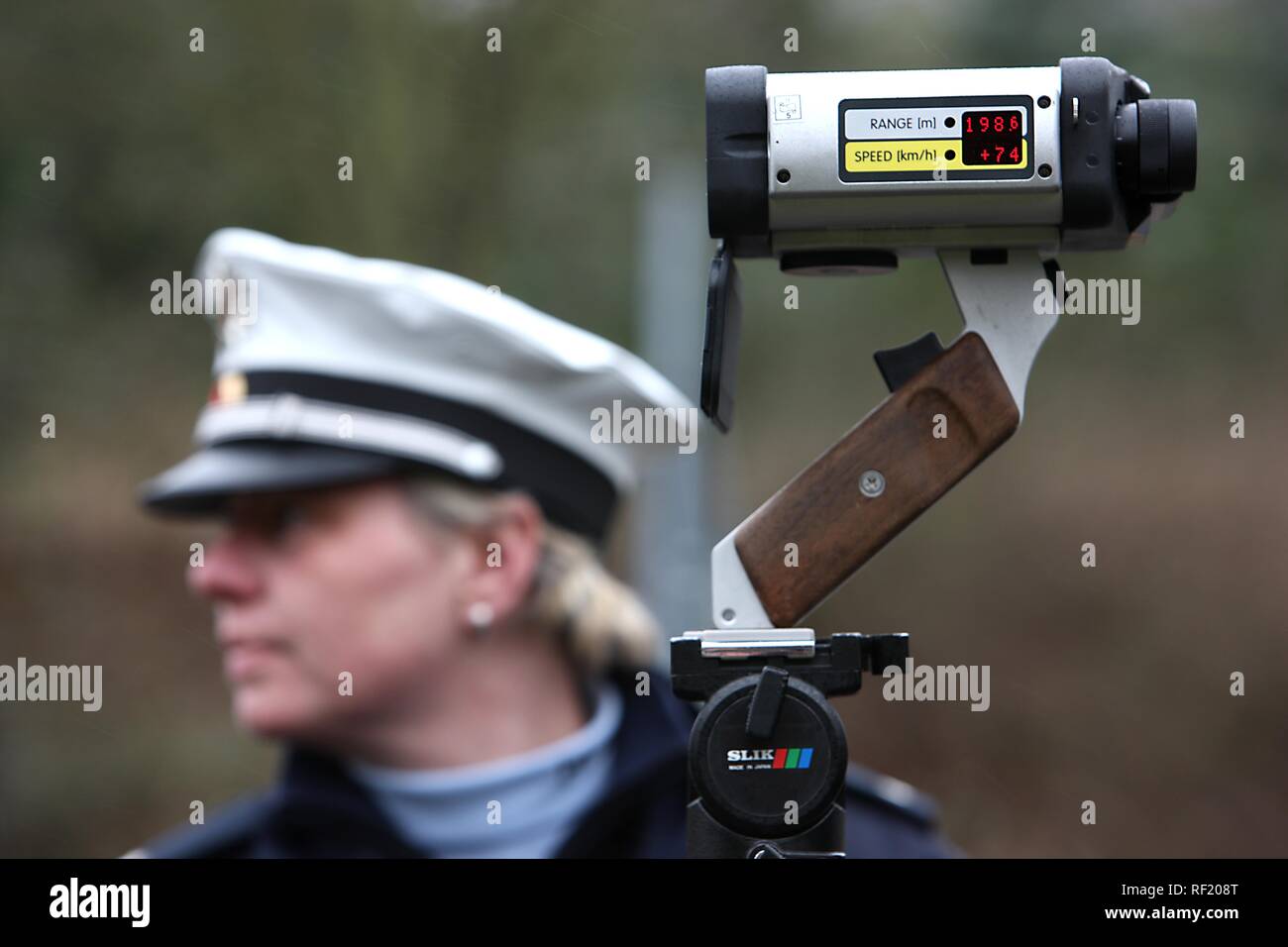 Speed limit enforcement, police measuring speed with a laser measuring