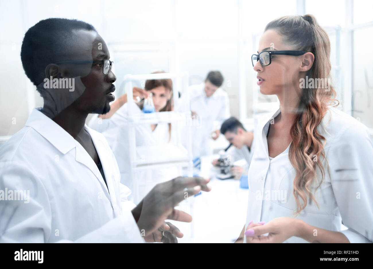 multinational scientists work in a modern laboratory Stock Photo