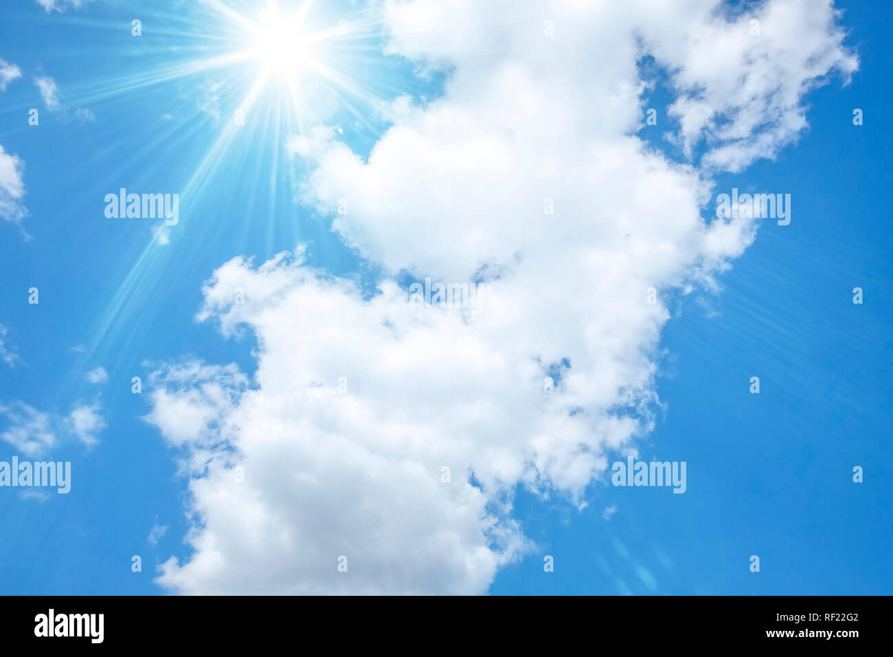 An image of a blue sky with bright sun and white clouds Stock Photo - Alamy