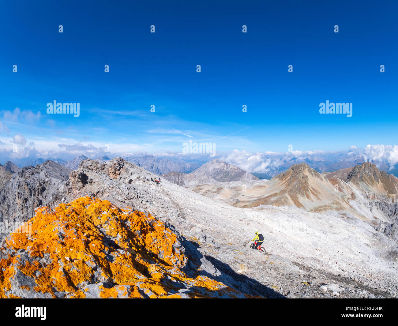 Border region Italy Switzerland, man riding mountainbike on trail at Piz Umbrail Stock Photo