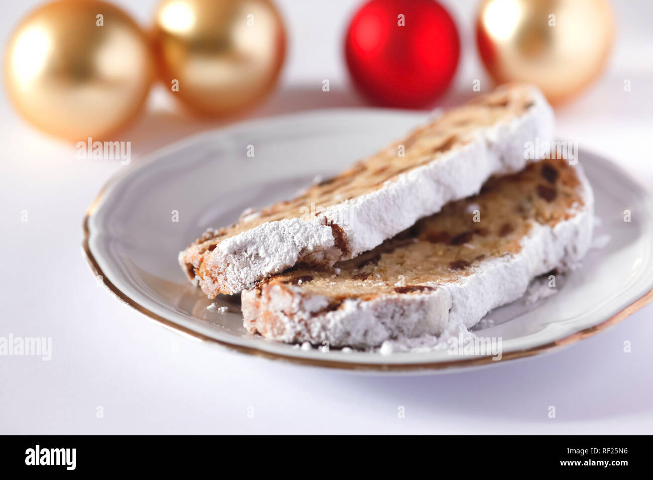 Slices of German Christmas stollen on a plate Stock Photo