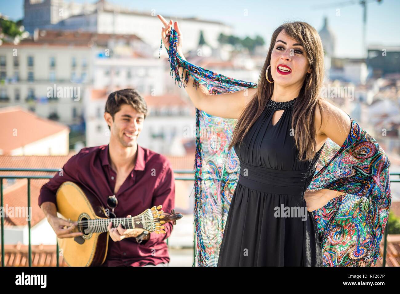 Fado singer performing with portuguese guitarist player in Alfama, Lisbon, Portugal Stock Photo