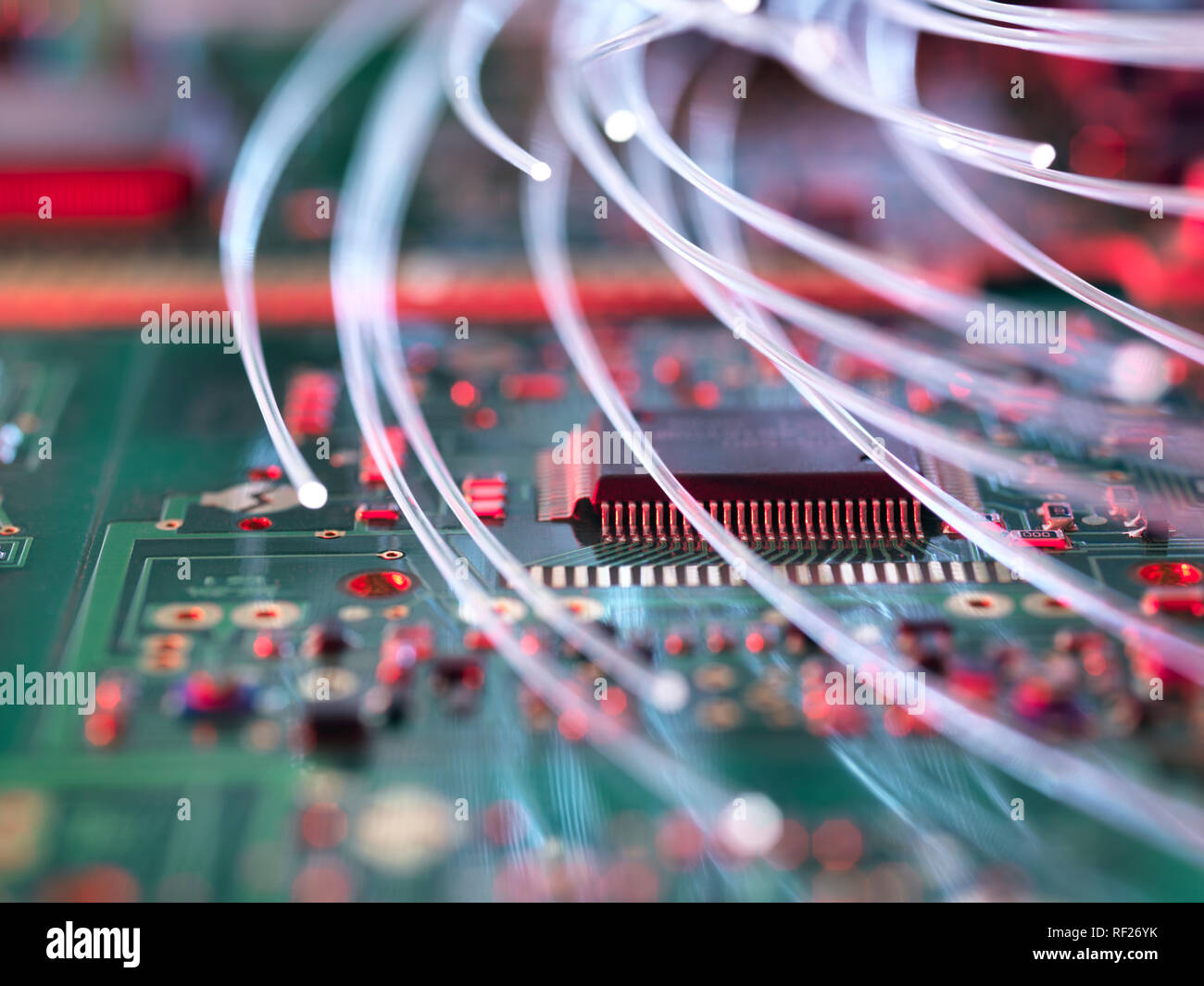Fibre optics attacking electronic circuit boards with a virus Stock Photo