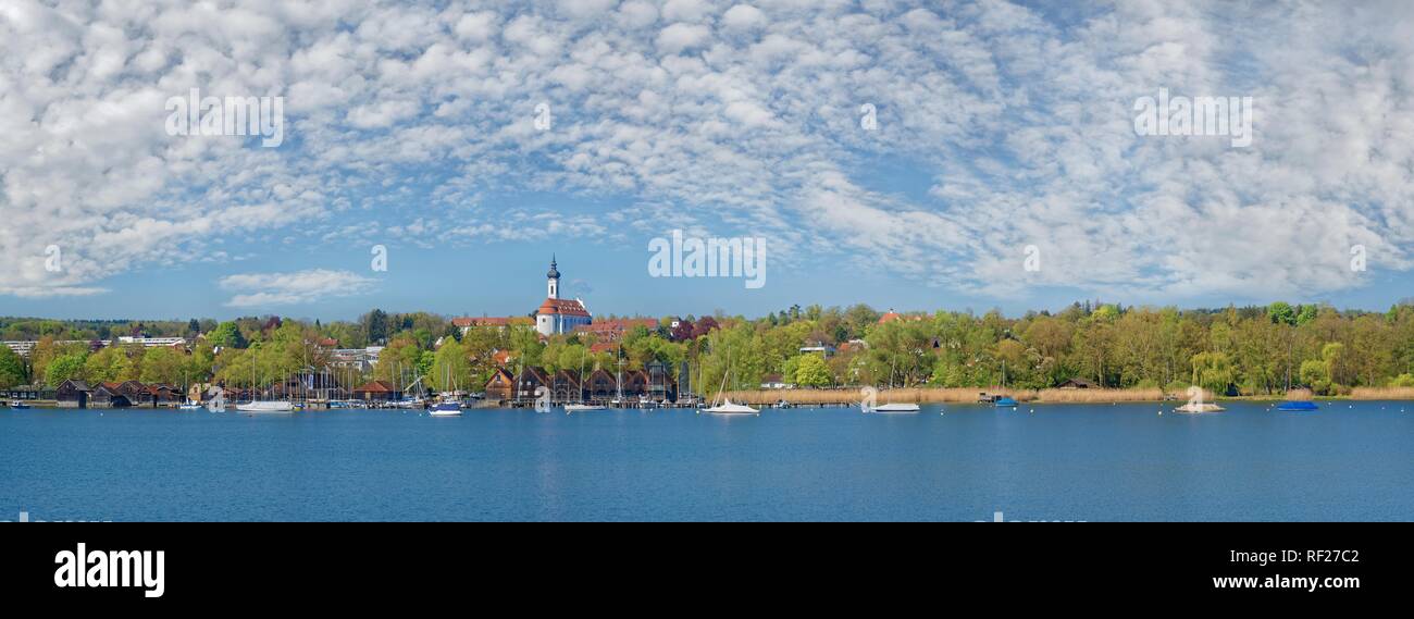 Lake Ammer shore with the Marienmünster and white-blue cloudy sky, Dießen, Lake Ammer, Bavaria, Germany Stock Photo