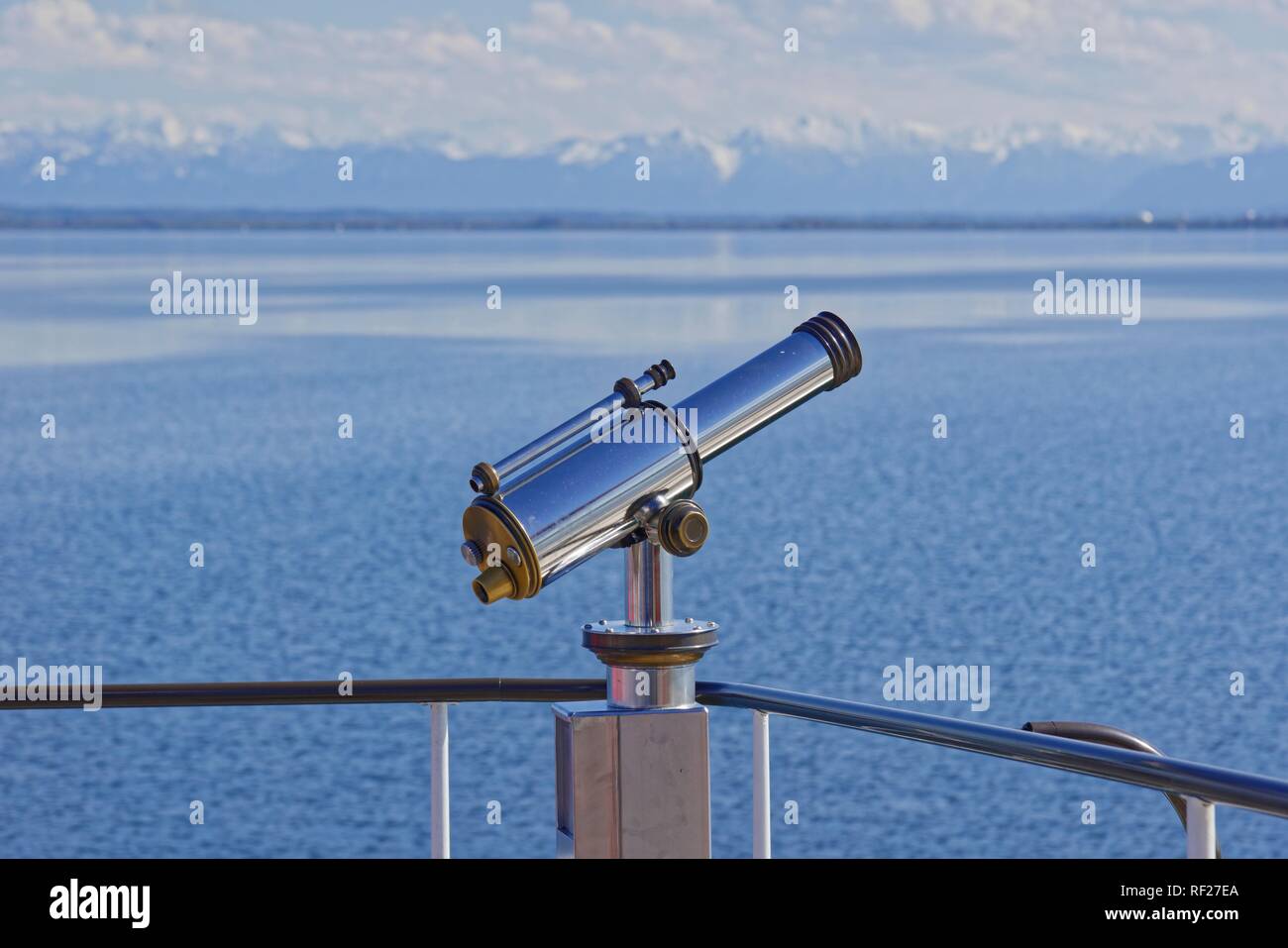 Binoculars with view to the snow-covered alpine peaks, Lake Ammer, Herrsching, Bavaria, Germany Stock Photo