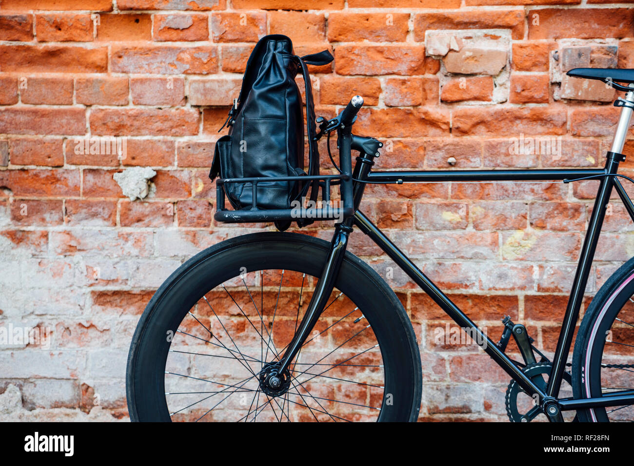Backpack in cargo cage of acustomised commuter fixie bike at brick wall  Stock Photo - Alamy