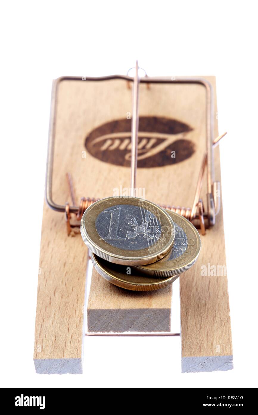 Symbolic shot coins caught in a mousetrap, debt, credit trap Stock Photo Alamy