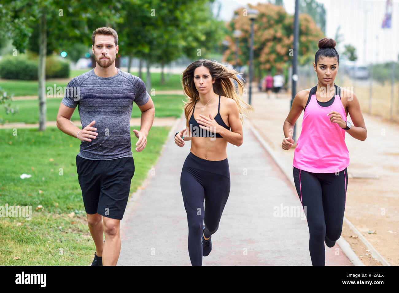 Young athletes running in a park Stock Photo