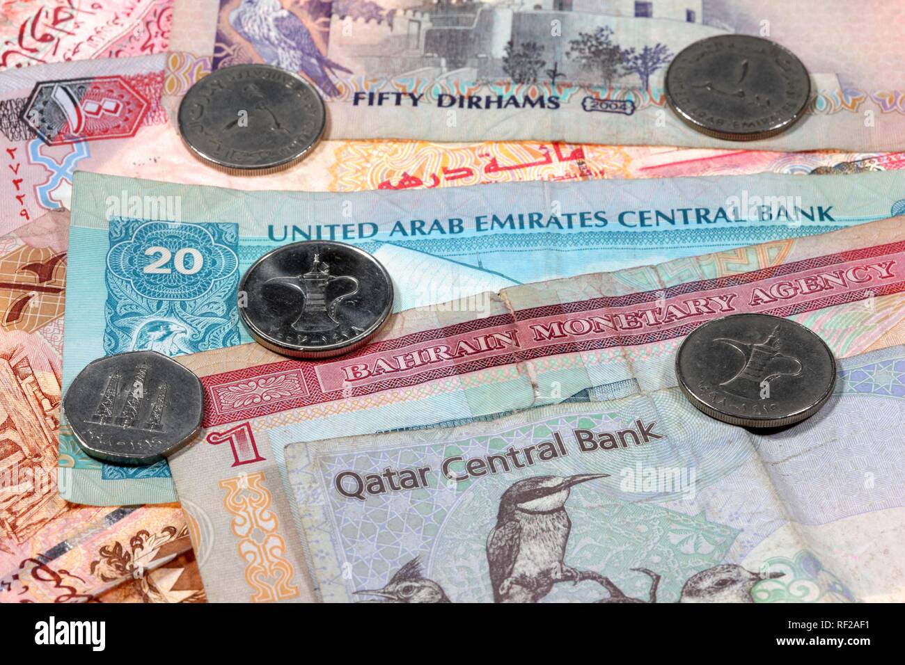 Banknotes and coins: currency of Qatar, Riyal, QAR, Bahrain Dinar, BHD, and the United Arab Emirates or UAE, Dirham, AED Stock Photo