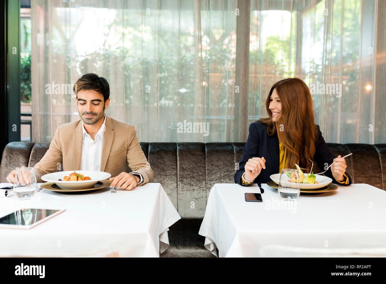 Smiling woman looking at man in a restaurant Stock Photo