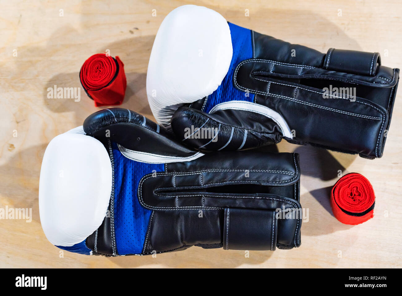 Two black, blue and white boxing gloves on light background Stock Photo