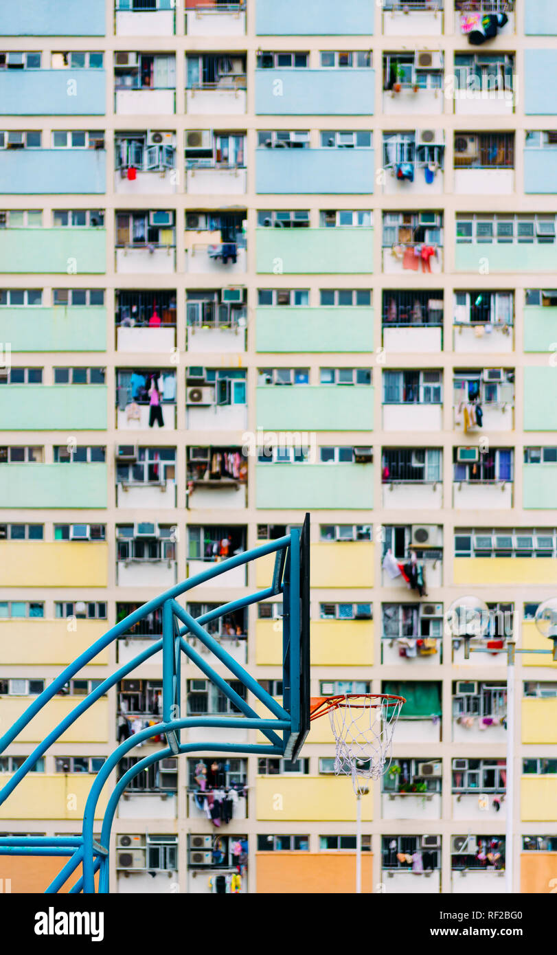 China, Hong Kong, Kowloon, basketball hoop, public housing in the background Stock Photo