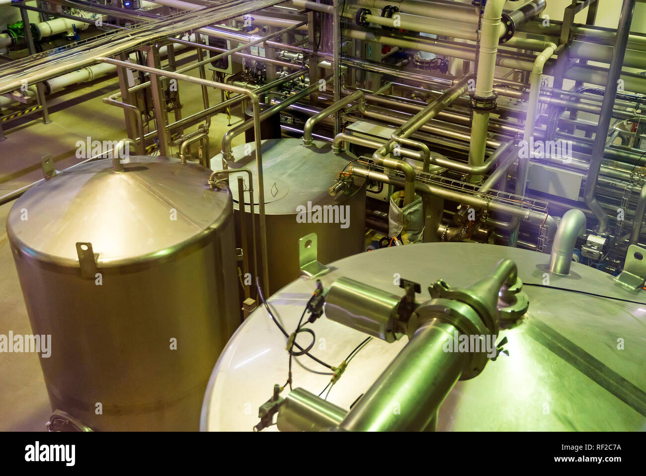 Metal reservoirs at a soft drink factory Stock Photo