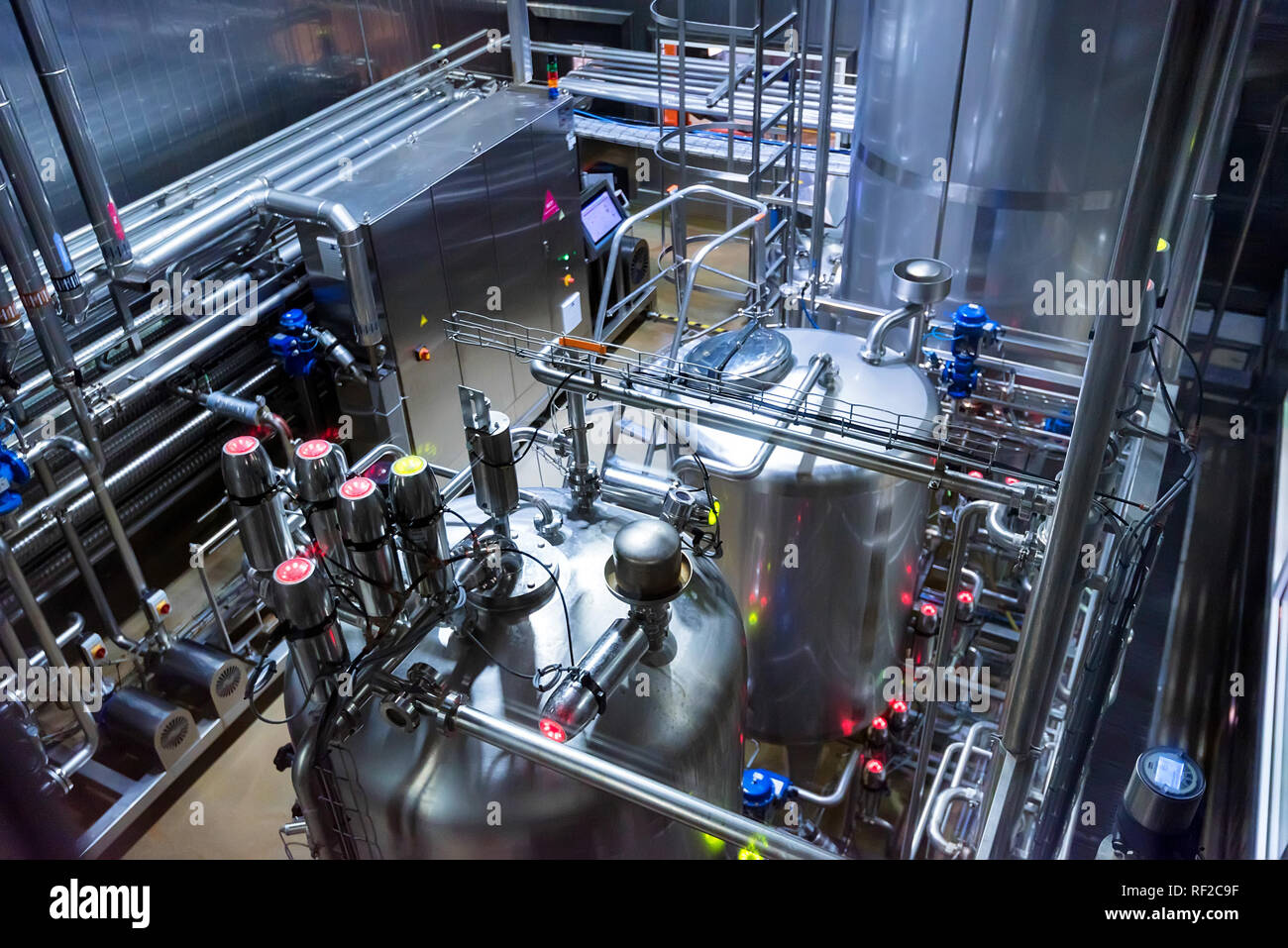 Metal reservoirs at a soft drink factory Stock Photo