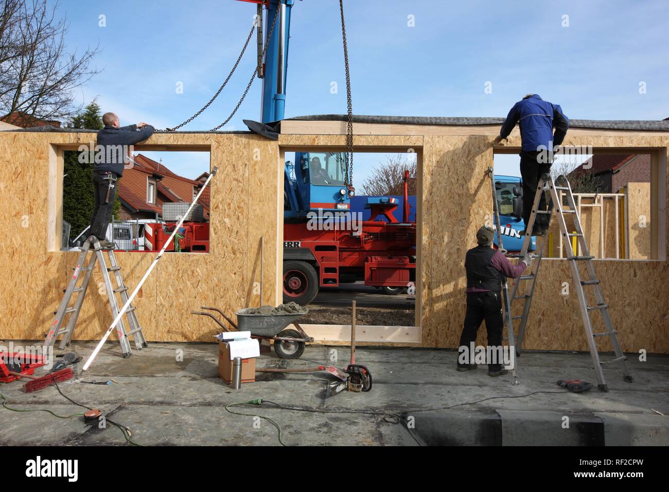 Carpenters building a wooden house, a onefamilyhouse using wooden