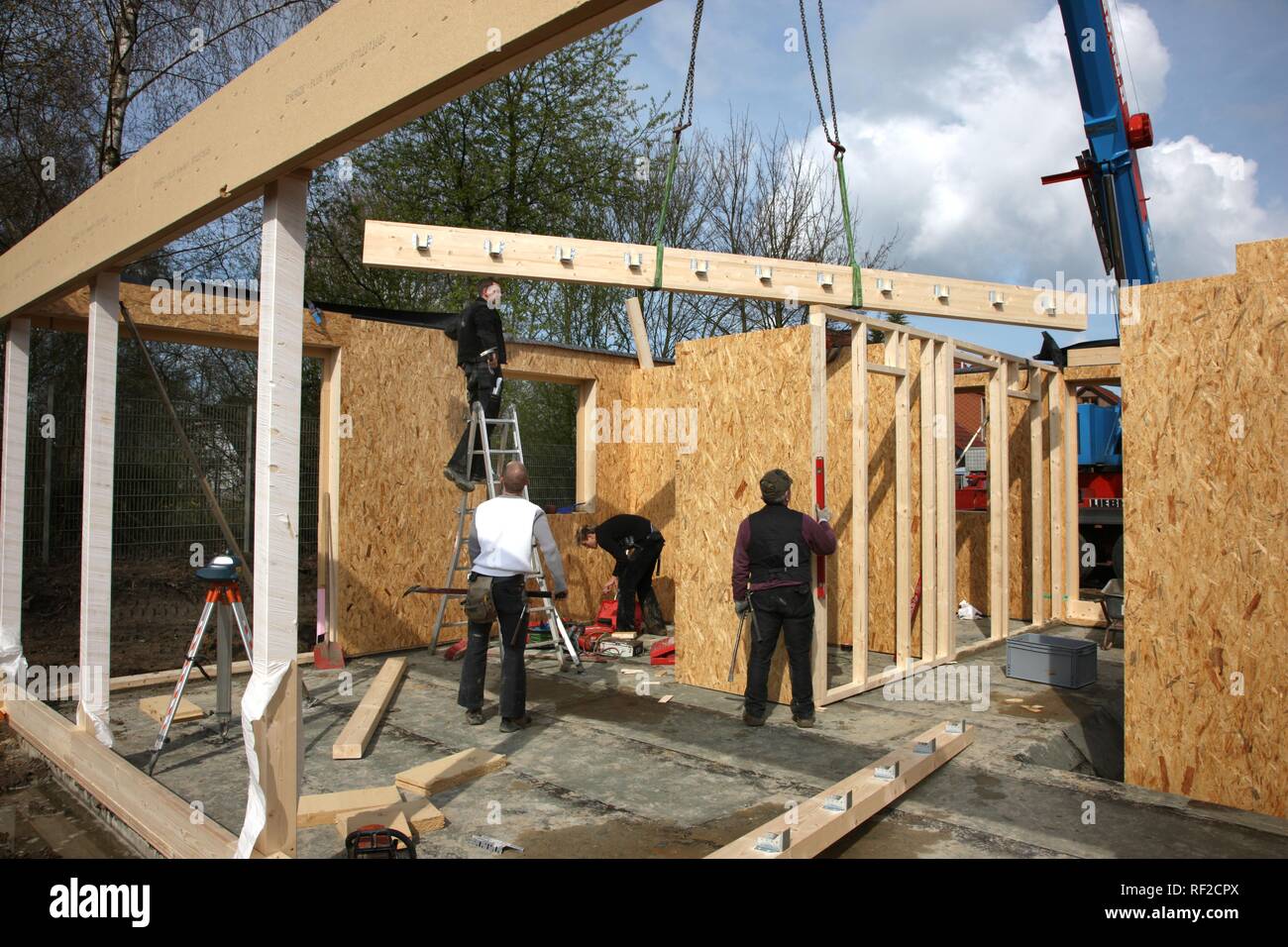 Carpenters building a wooden house, a onefamilyhouse using wooden framework, lowenergy house