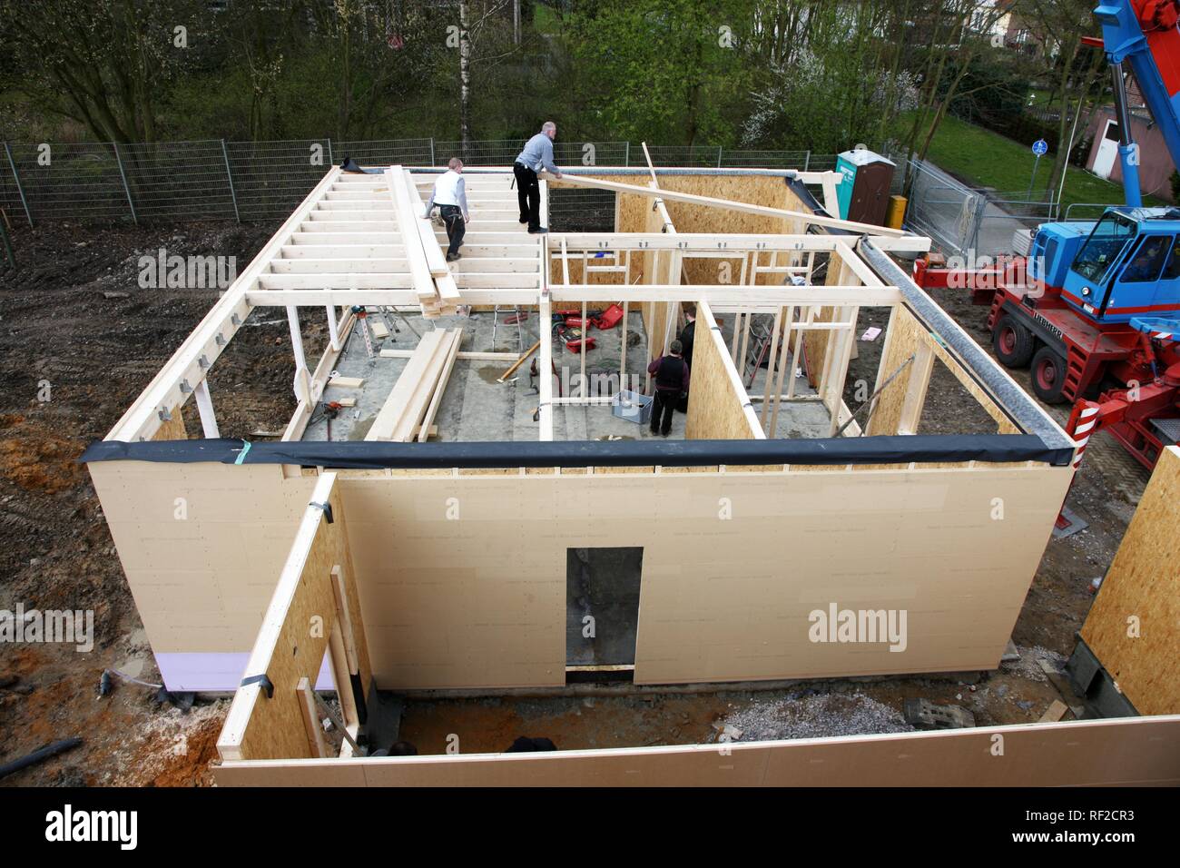 Carpenters building a wooden house, a onefamilyhouse using wooden